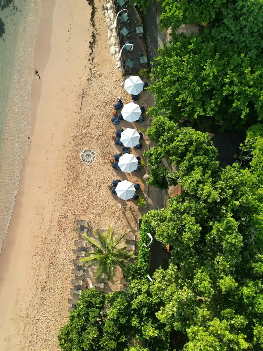 Aerial view of a white-sand beach and resort umbrellas in Nusa Dua