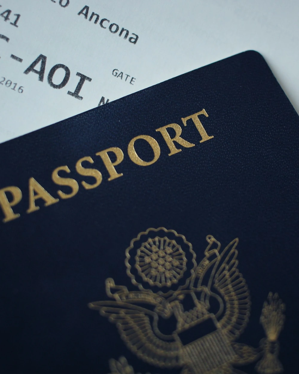Passport resting on a boarding pass before a flight to Bali