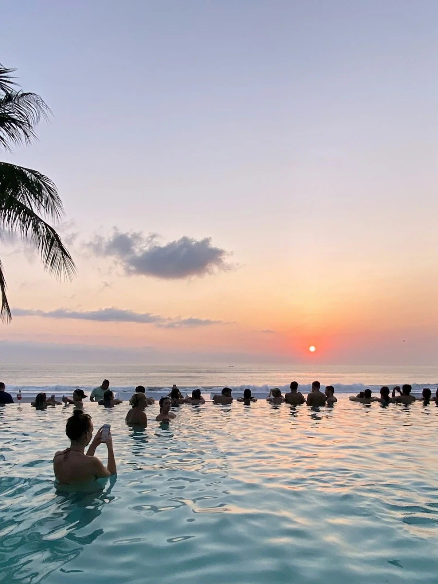 Infinity pool facing the ocean at sunset in Bali