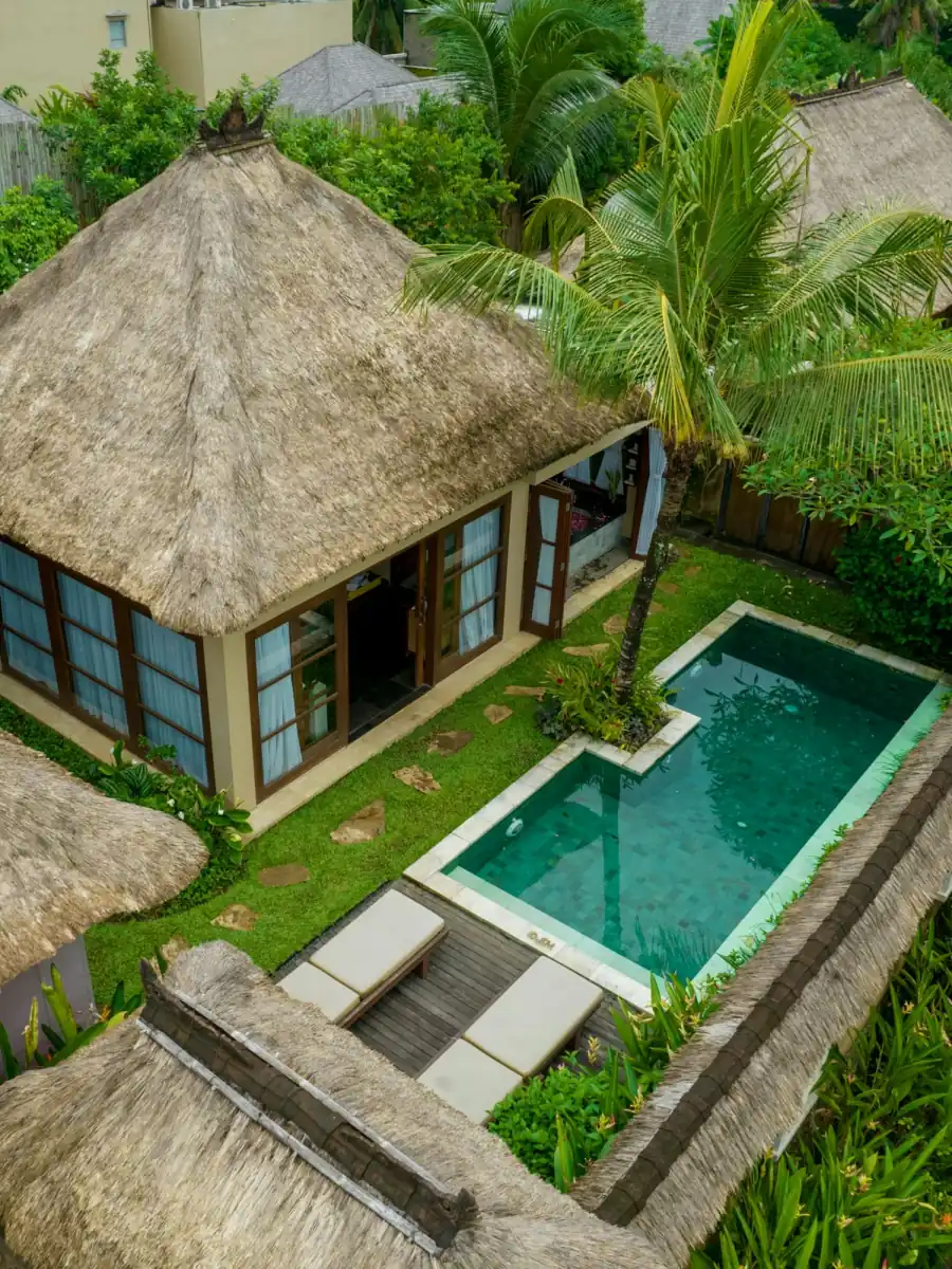 Thatched-roof villa with a private pool in a Bali garden